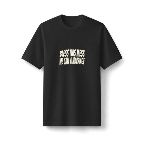 "Bless This Mess We Call a Marriage" funny couples graphic on a black Next Level heavyweight oversized tee - Couples Therapy Apparel